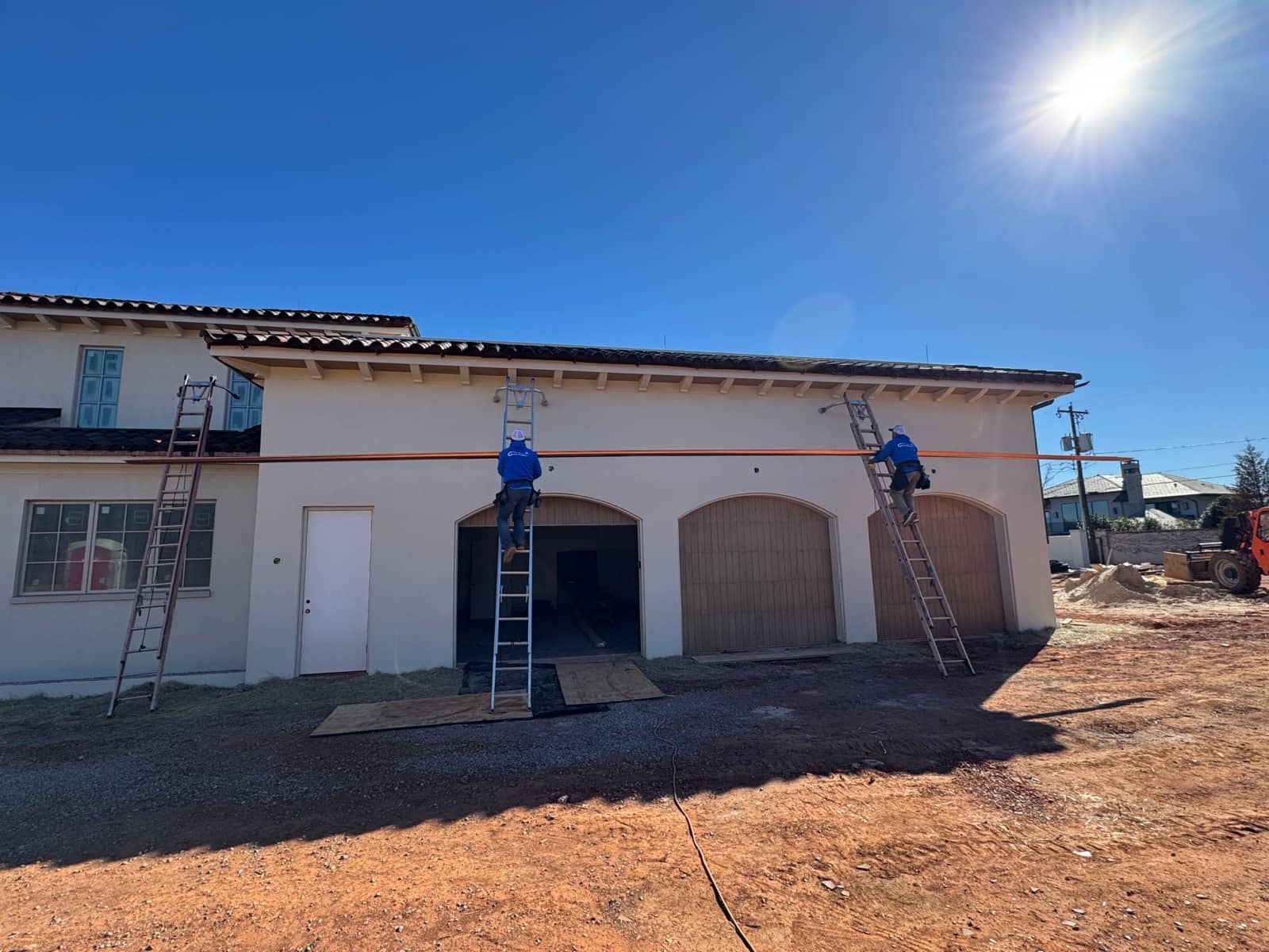 Rain Tamer crew on ladders during an install.