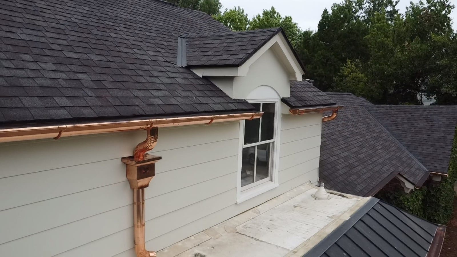 Hand-formed copper collector box on a copper half-round install.